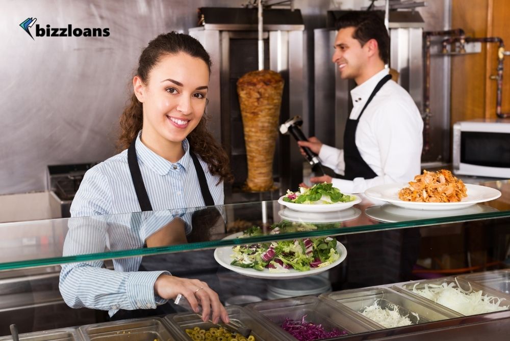 Tips-Towards-Effective-Staff-Management happy staff posing at a kebab counter