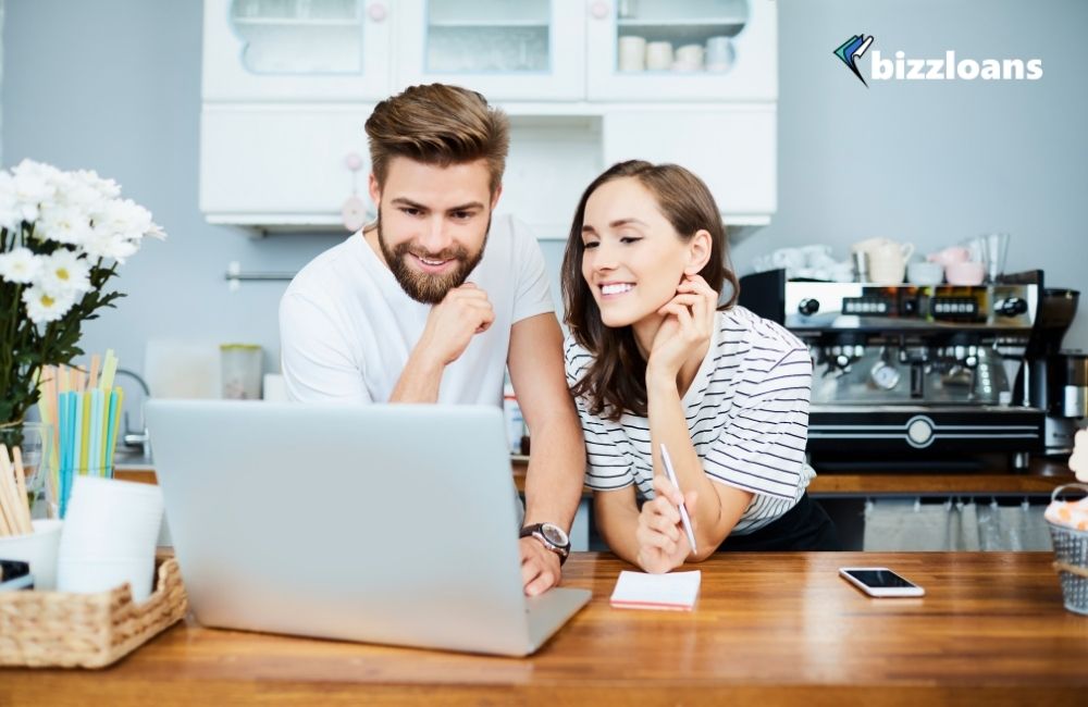 10-important-financial-tools-every-small-business-should-consider happy couple using a financial tool for their business on a laptop