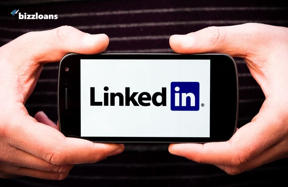 10-linkedin-marketing-tips-to-grow-your-small-business hand holding a Smartphone displaying LinkedIn Logo