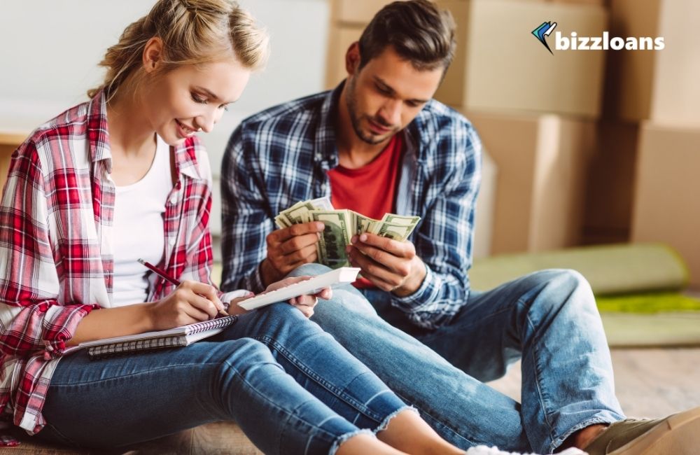 7-signs-your-small-business-needs-funding-to-survive two business owners counting money to fund their business