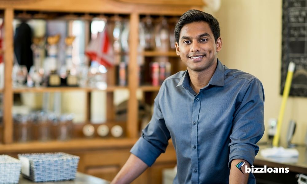 8-mental-health-tips-for-small-business-owners-1 business owner smiling in his shop
