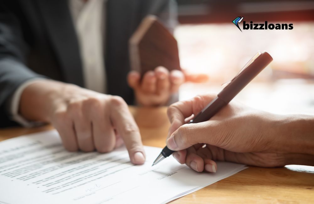 getting-a-business-loan-with-no-personal-guarantee business loan agent showing client where to sign as personal guarantee