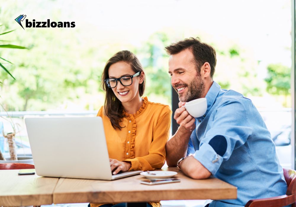 the-aussie-borrowers-guide-understanding-business-loan-interest-rates-in-australia Two restaurant owners discussing business loans interest rates on laptop